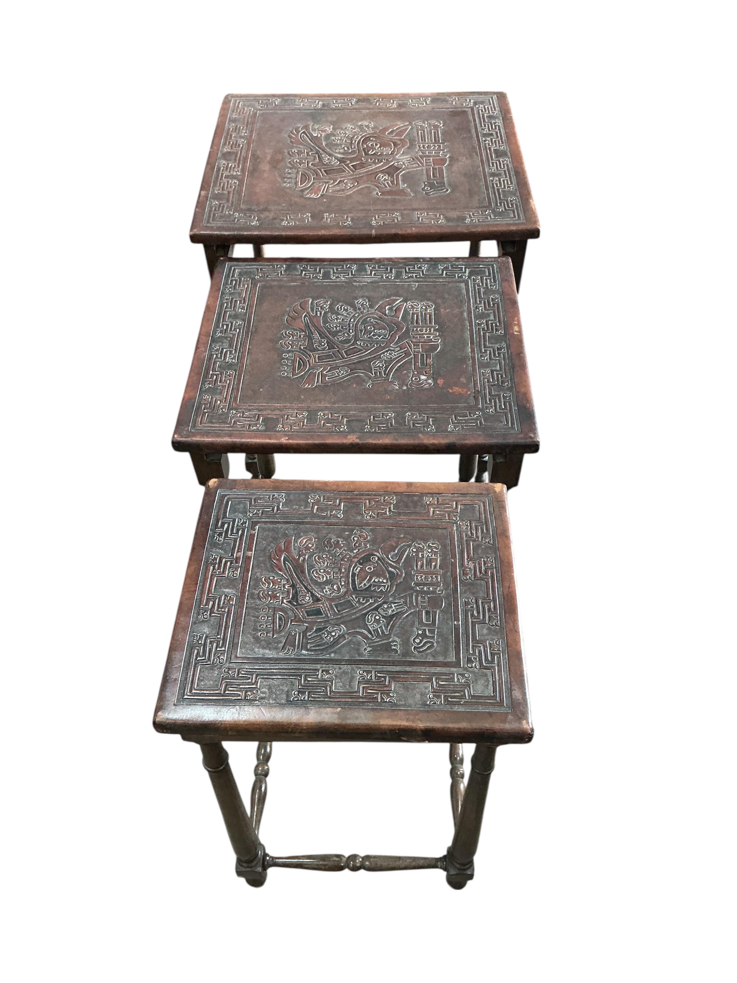 A Peruvian rectangular embossed leather turned wood coffee table, width 128cm, depth 50cm, height 42cm together with a similar nest of tables